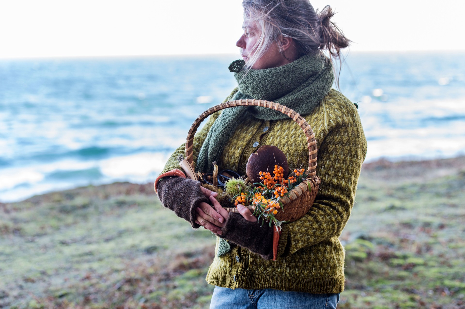 Food forager in traditional clothes by the sea